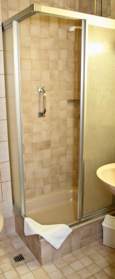 Shower, hair dryer, slippers, towels