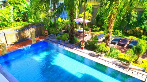 Outdoor pool, open 7:00 AM to 9:00 PM, pool umbrellas, sun loungers