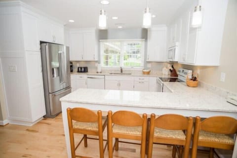 Your bright, fully equipped kitchen awaits—gleaming countertops, modern appliances, and a spacious island where you can gather for morning coffee or prepare a leisurely meal together.