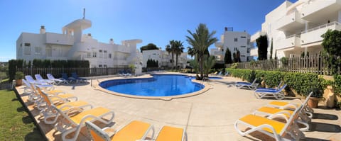 Residential El Puerto I community swimming pool with a large solarium area.