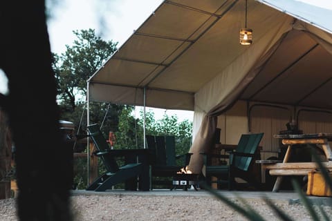 Spacious glamping tent with covered outdoor living space, cozy beds, dining area, and everything you need for a comfortable Southern Utah stay.