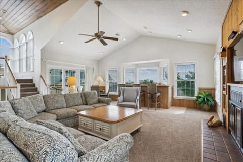 Settle into your spacious, light-filled living area where vaulted ceilings and coastal breezes invite you to unwind after a day of exploration.