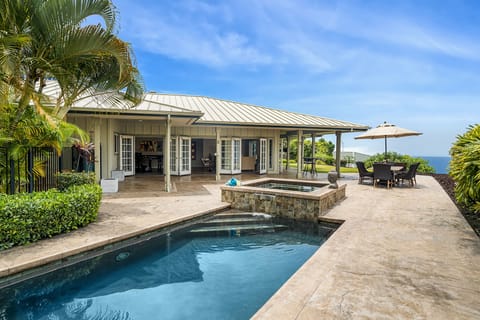 Soak in island serenity from the pool or shaded lanai, with Kona’s coastline on the horizon.