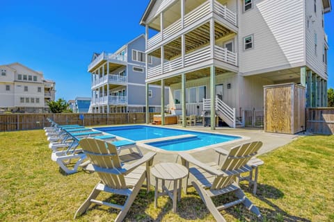 Enjoy sunny days lounging by your private pool surrounded by spacious decks—perfect for gathering with friends and family in coastal comfort.