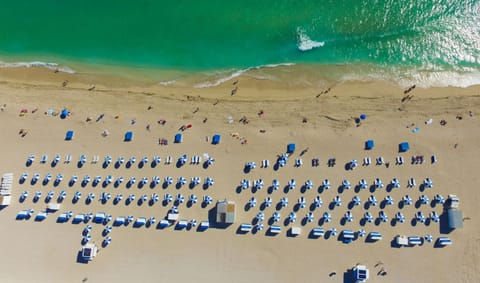 Beach nearby, white sand, sun loungers, beach towels