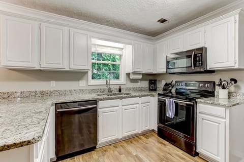 Kitchen with granite countertops open to living room