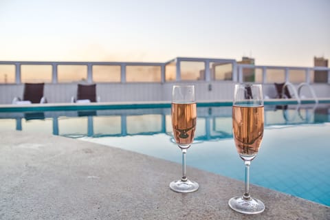 Outdoor pool, a rooftop pool, open 7:00 AM to 10:30 PM, sun loungers