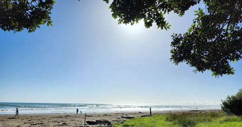 Beach nearby, white sand, beach towels, surfing