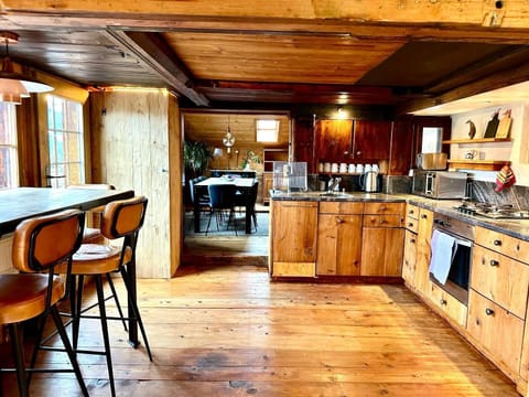wooden kitchen with small kitchen high table 
