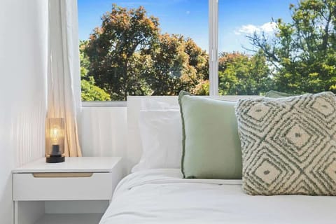Your comfortable haven awaits. Enjoy a great night's sleep with our cozy bedding and thoughtful bedside setup. Embrace the calming green views right outside your window.