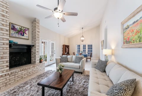 Very airy living and dining area with views through french doors to back patio. 
