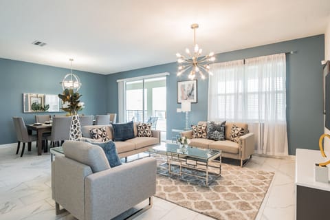 Unwind in your open-concept living space with its modern charm and soft lighting. Relax on stylish seating or enjoy meals at the elegant dining table—all within a welcoming retreat designed for comfort.