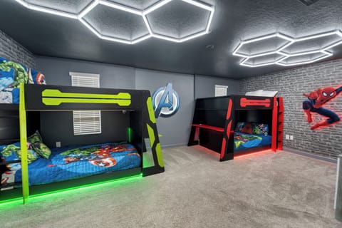 Your little heroes will love this epic superhero-themed bedroom with custom bunk beds and futuristic lighting. Adventures await when bedtime becomes playtime.