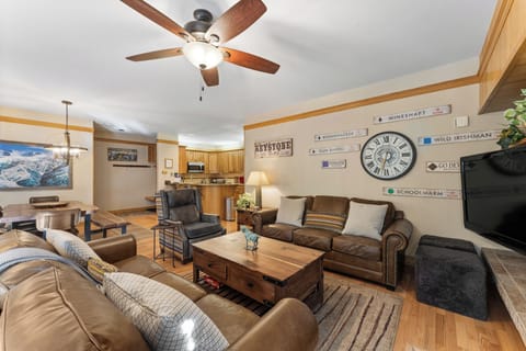 Living area featuring a wood burning fireplace, flat screen TV, and ample seating.