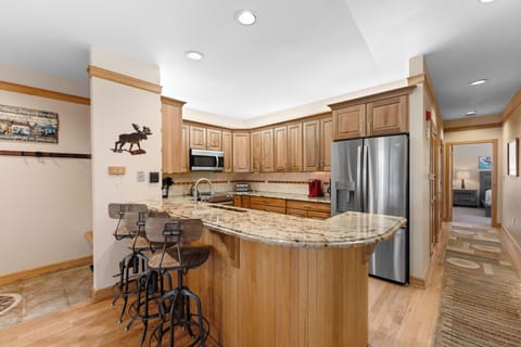 Full kitchen featuring stainless steel appliances, including a wine fridge.
