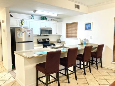 Open Spacious Floor Plan - Kitchen with Dining Bar and Family Room.