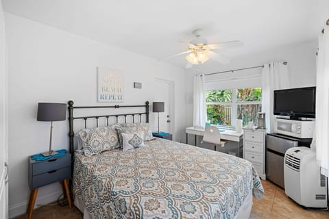 Bedroom with queen bed and work space.