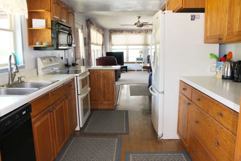 Spacious kitchen fully stocked: dishes, pots, pans, utensils, & spices.