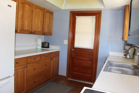Spacious kitchen fully stocked: dishes, pots, pans, utensils, & spices.