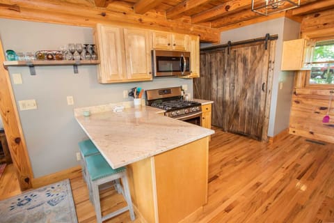 Kitchen Boasts Stainless Appliances and Granite Counters, Custom Barnwood Sliding Door hides Washer and Dryer
