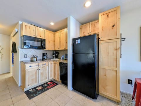 Your fully equipped kitchen features warm wood cabinets, full-size appliances, and everything you need to prepare meals during your stay.