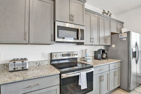 The kitchen features granite counters and stainless steel appliances