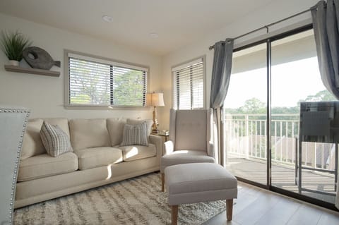 Carolina Beach Club 429 - Living Room - Charming bright living room and sliding door to balcony enjoy side view of the amazing  Atlantic Ocean .