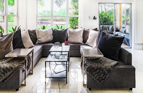 Open floor plan with plenty of seating inside and outside. Living room and patio overlooking the pitch and putt.
