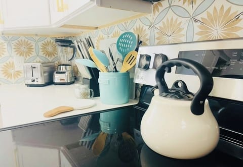 All kitchen necessities, kettle, blender, toaster, knives and utensils.