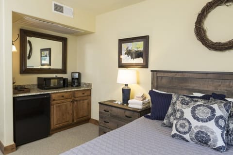 Wet bar with mini fridge,microwave, and coffee maker.