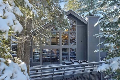 Winter exterior of the cabin showcasing its cozy charm, complete with free on-site parking for your convenience.