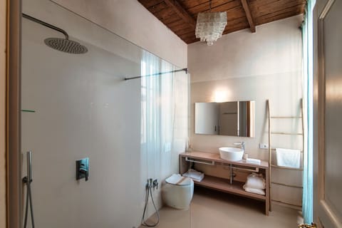 Studio Suite | Bathroom | Hair dryer, slippers, towels, soap