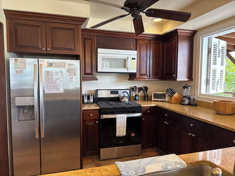 The granite and mahogany kitchen is well equipped