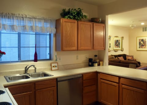 Kitchen. Furniture in living room has been replaced with new set.