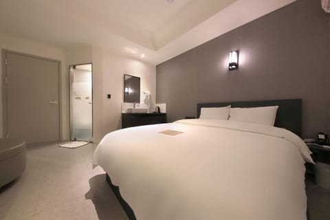 Premium bedding, desk, laptop workspace, blackout drapes