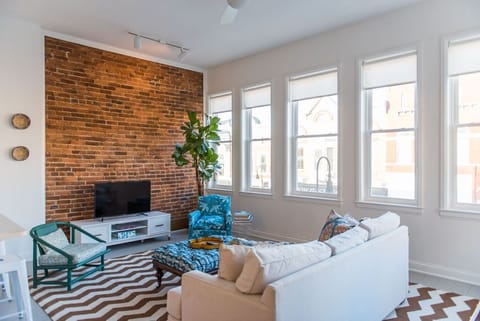 Living room, 7 windows overlooking Main St. Versailles. Fabrics by Ferrick Mason