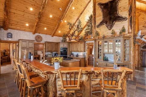 Long Breakfast Bar facing fully stocked granite kitchen.