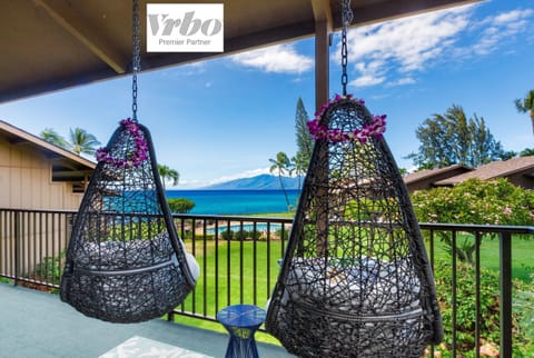 A peaceful lanai retreat with cozy seating and sweeping ocean vistas.