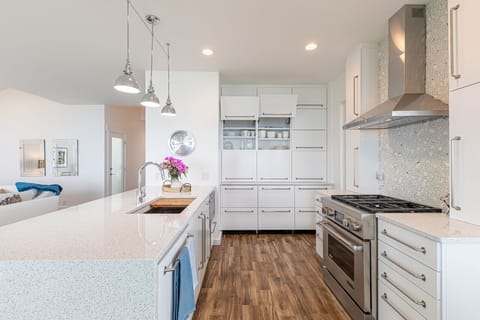 Quartz countertops, built in frig drawers, farm sink, gas range, custom cabinets