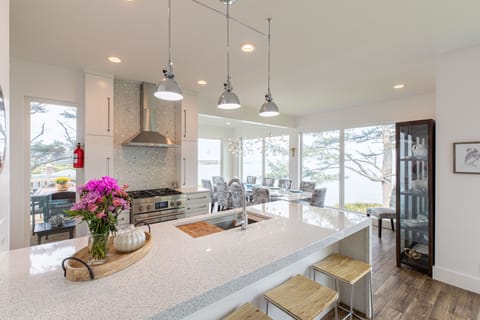 Quartz countertops, pendant lights, breakfast bar with 4 chairs, great views.