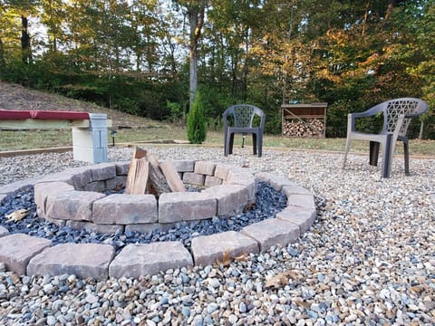 View of the firepit in the private back yard. Firewood is always stocked.