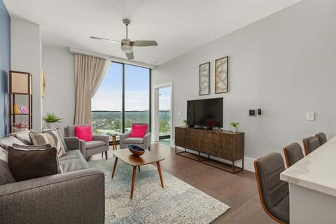 Living room with 55 inch TV, sleeper sofa, additional seating and slider window