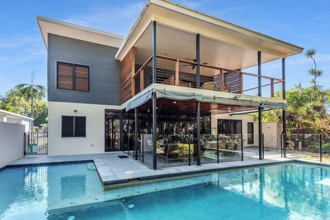 This dual-level oasis sits on a paradise of a location with access to the beach and a large private pool.