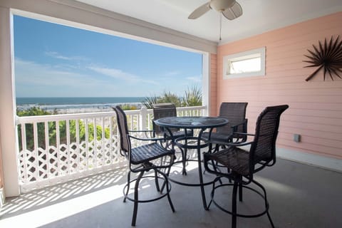 Sip your morning coffee on this covered balcony with stunning ocean views, where the sea breeze and gentle waves create your perfect retreat.