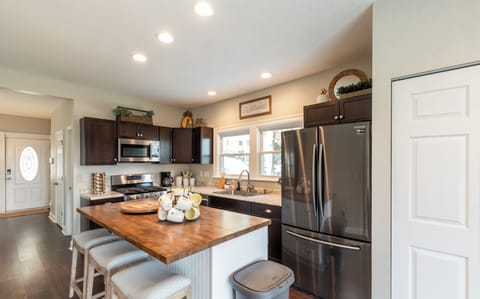 Large open kitchen with island and new stainless steel appliances.