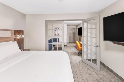 Premium bedding, desk, laptop workspace, blackout drapes