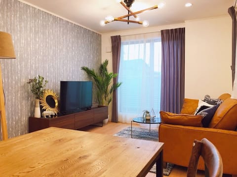 Three-Bedroom Apartment | Living room | 65-inch flat-screen TV with digital channels, TV