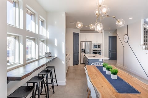 Dining Table - Share memories and stories while enjoying a family style meal around the Dining Table with extra seating at the bar top and kitchen island.