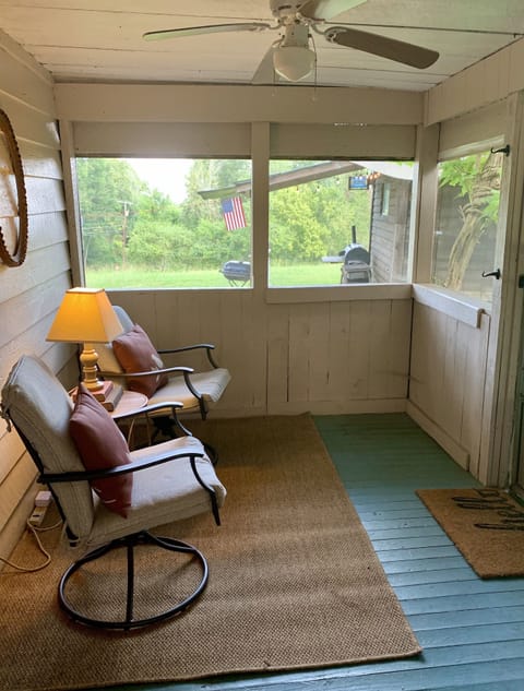 The sun rises on the screened in porch at rear of home, perfect for mornings. 