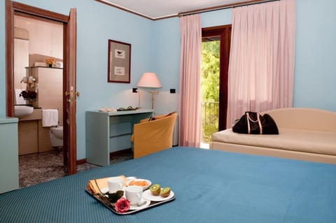 Triple Room | Pillowtop beds, minibar, in-room safe, individually decorated